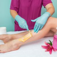 leg-sugaring-beautician-makes-sugar-paste-depilation-woman-s-legs-beauty-salon-female-aesthetic-cosmetology-apply-sugar-paste-with-wooden-spatula_357889-5213