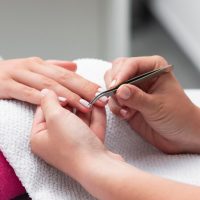 woman-doing-manicure-client-close-up_23-2148697076